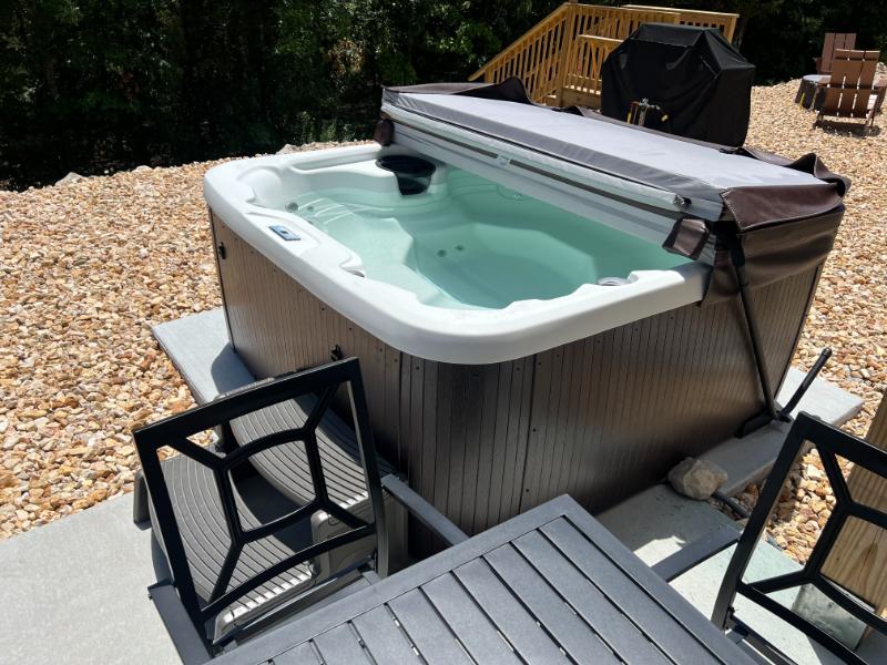 Soak your cares away in the hot tub just right off the back patio
