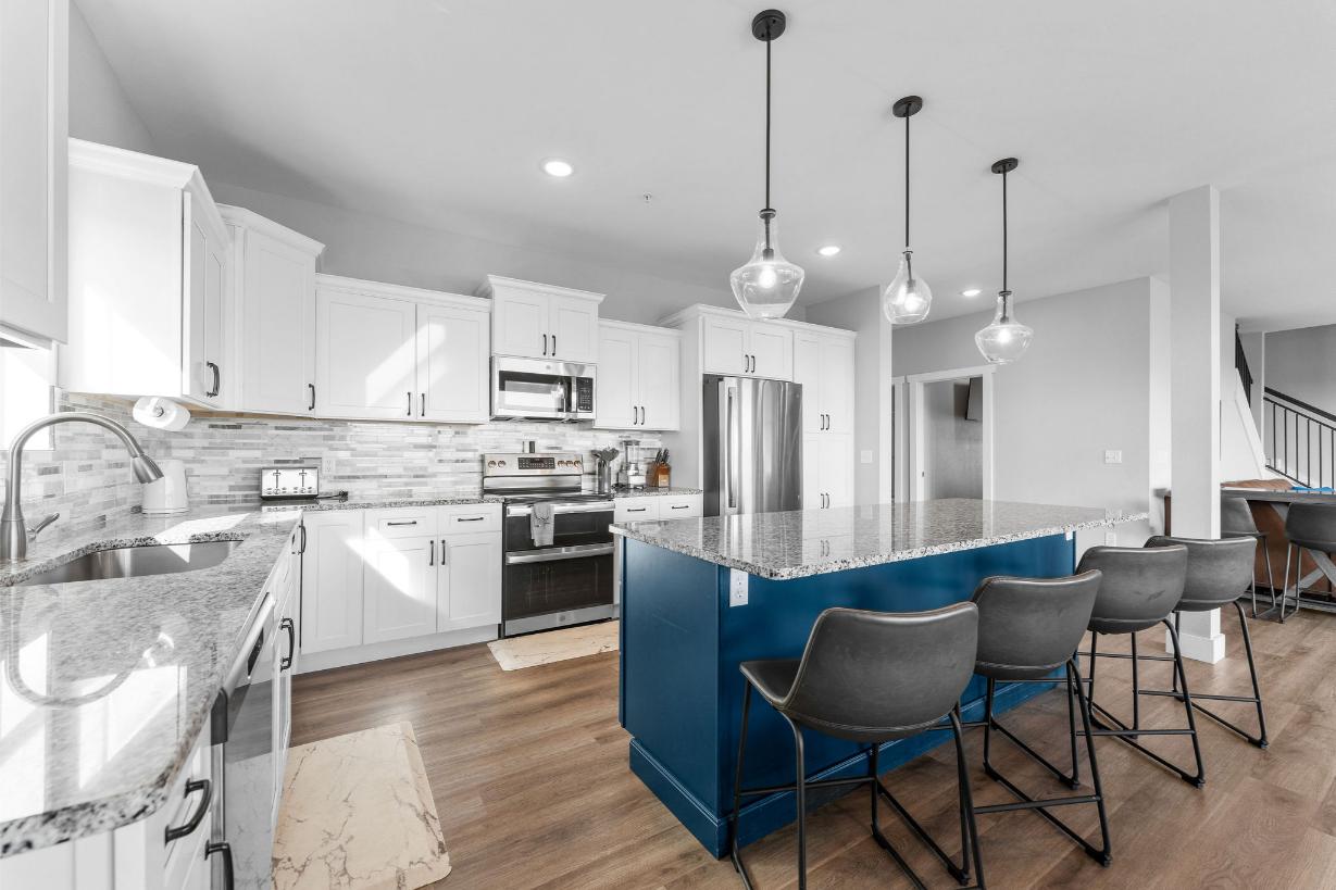 The kitchen is fully stocked and includes a double oven
