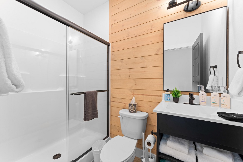 The elegant ensuite features a walk-in glass shower and contemporary design for a clean, relaxing vibe.