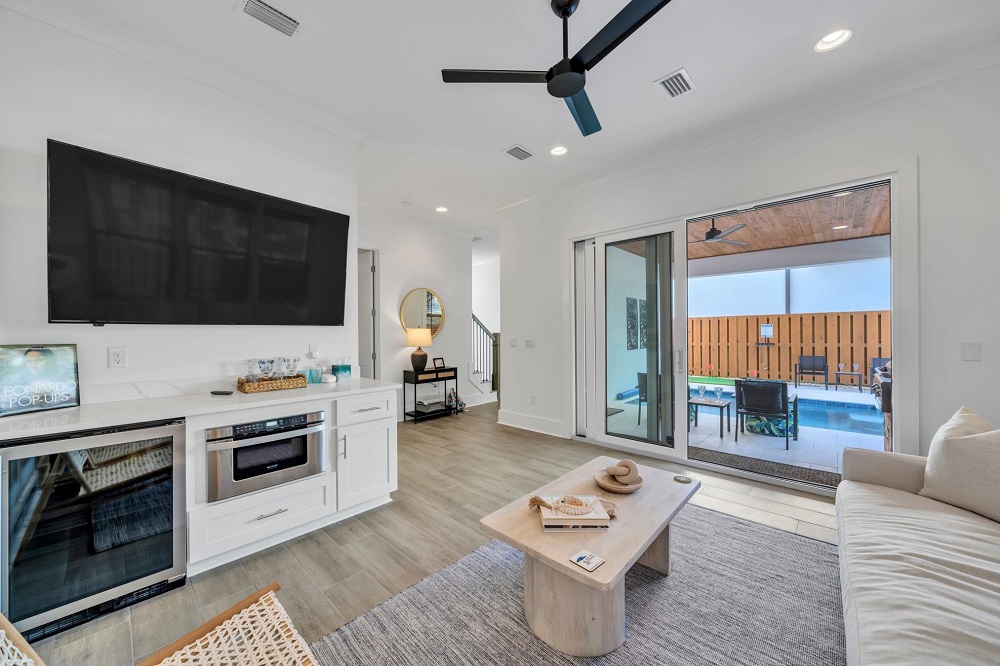 Slide open the doors and let the breeze in—this cozy den flows straight out to the covered patio!