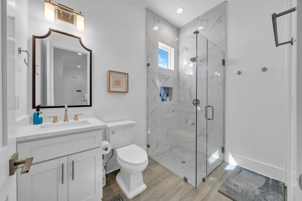Easy access and elegant style—this main-level bathroom connects to both the bedroom and den for ultimate convenience.
