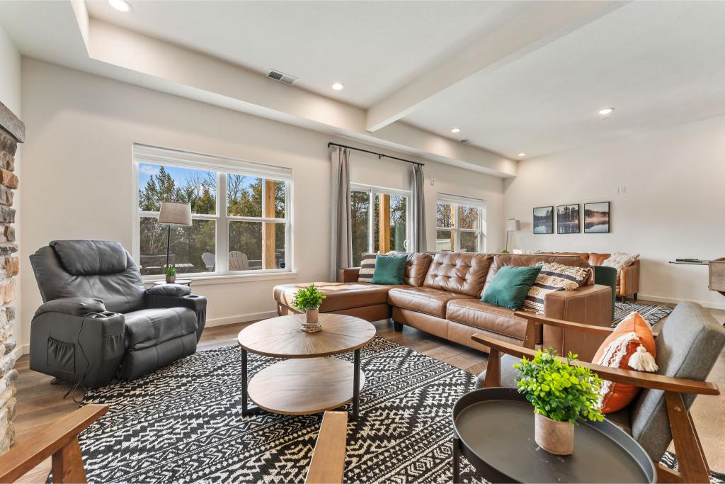 The main floor living area includes various seating, fireplace, smart TV and massaging recliner