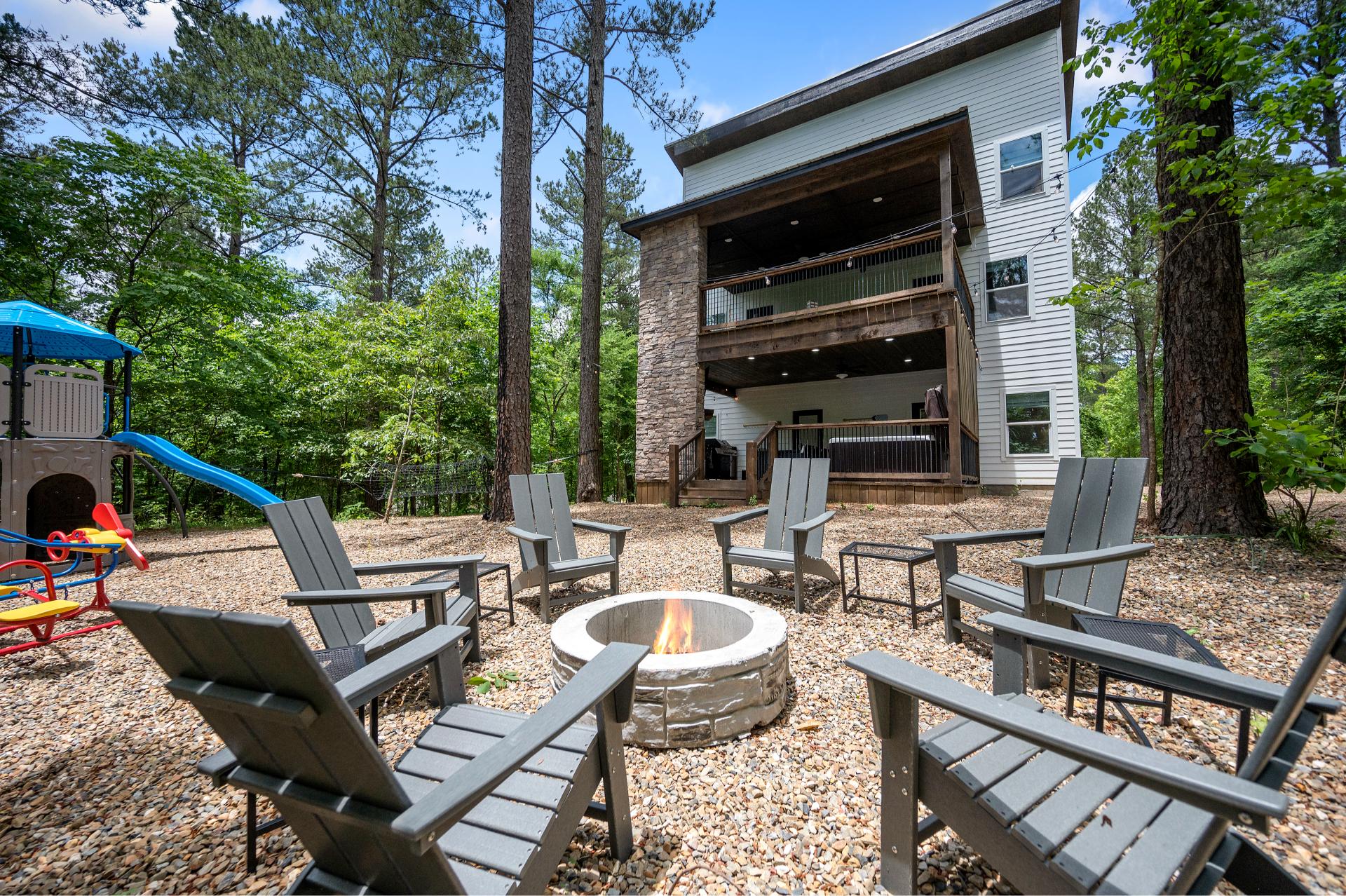 Let the kids run wild on the playsets while you kick back by the fire—this backyard has room for memory-making all around.