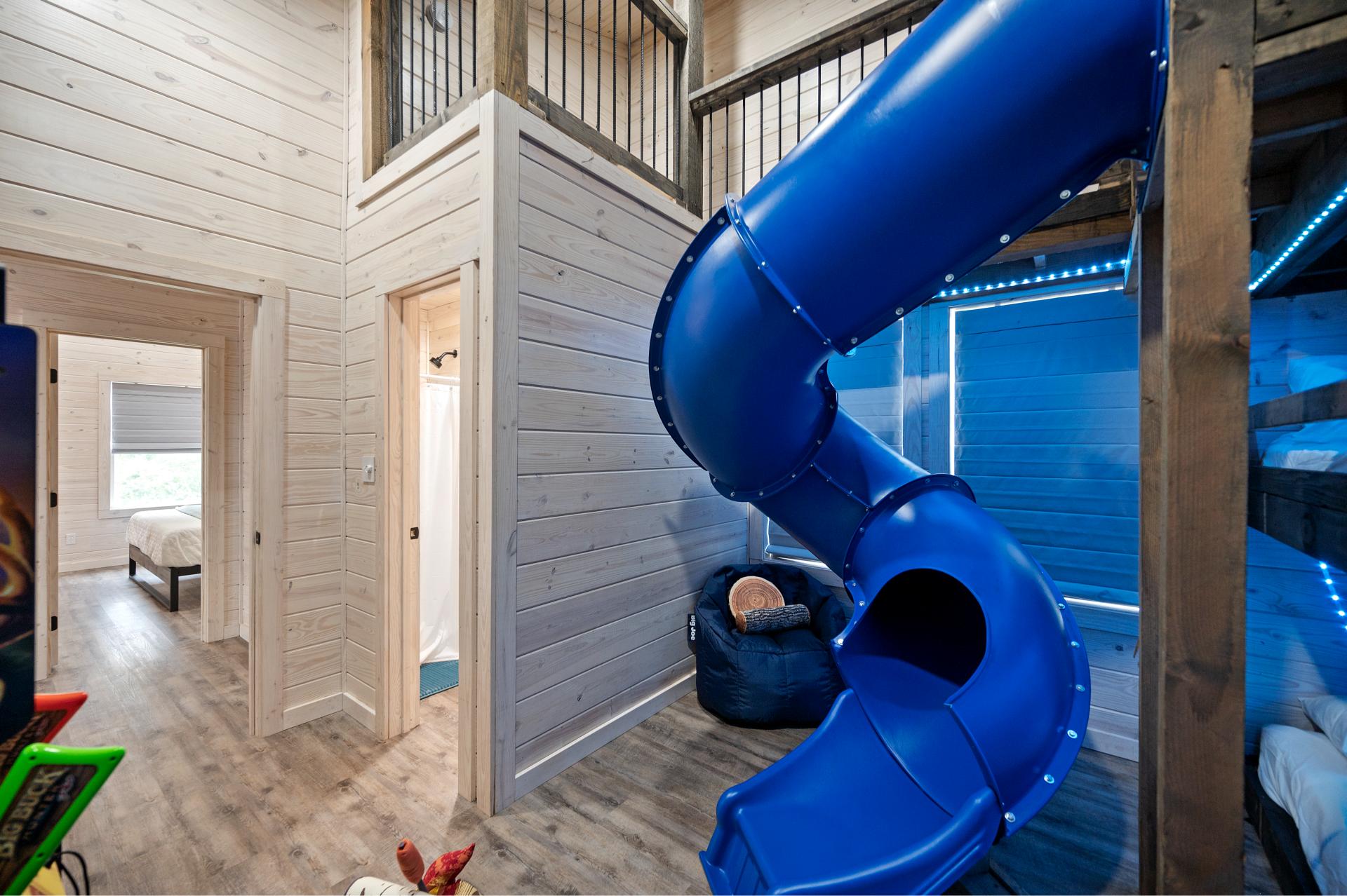 Slides, stories, and sleepovers await! This bunk room is a dream come true for kids with built-in fun from floor to ceiling.