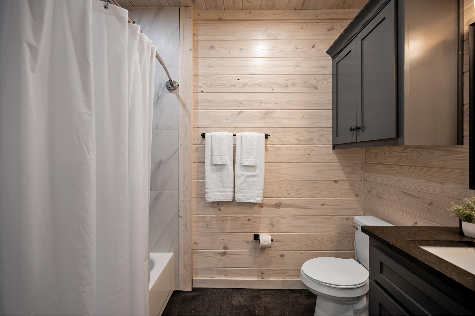 Soak or rinse off the day in this spacious bathroom—complete with room to stash your stuff and settle in.