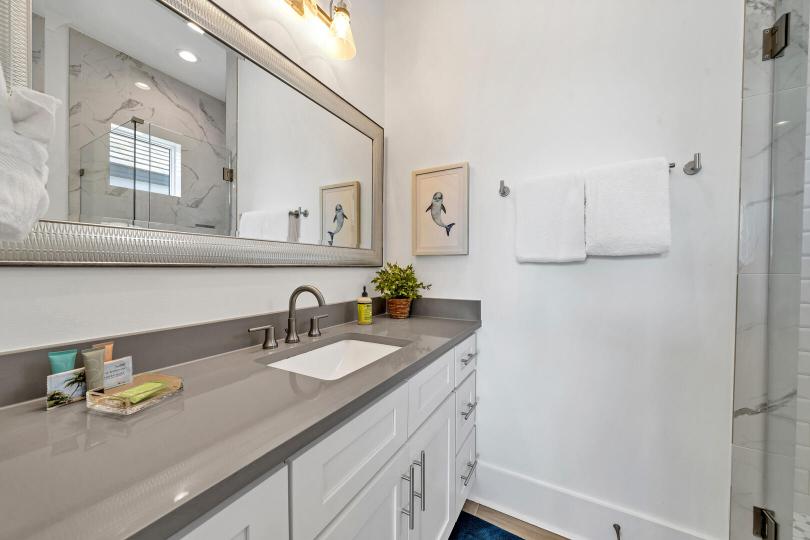 Third-floor Dolphin Bathroom with a tiled shower, vanity, and private access—ideal for comfort and convenience.
