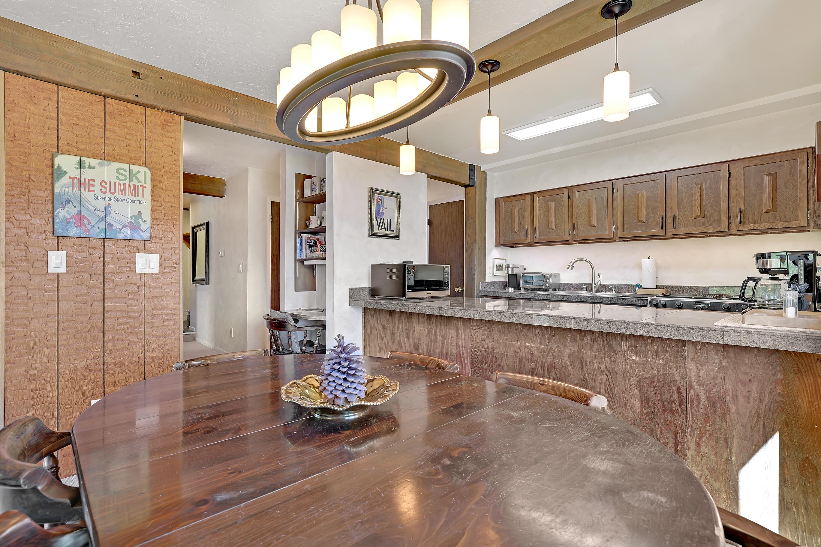 Kitchen is fully stocked with plates, glasses, and silverware plus large and small appliances.
