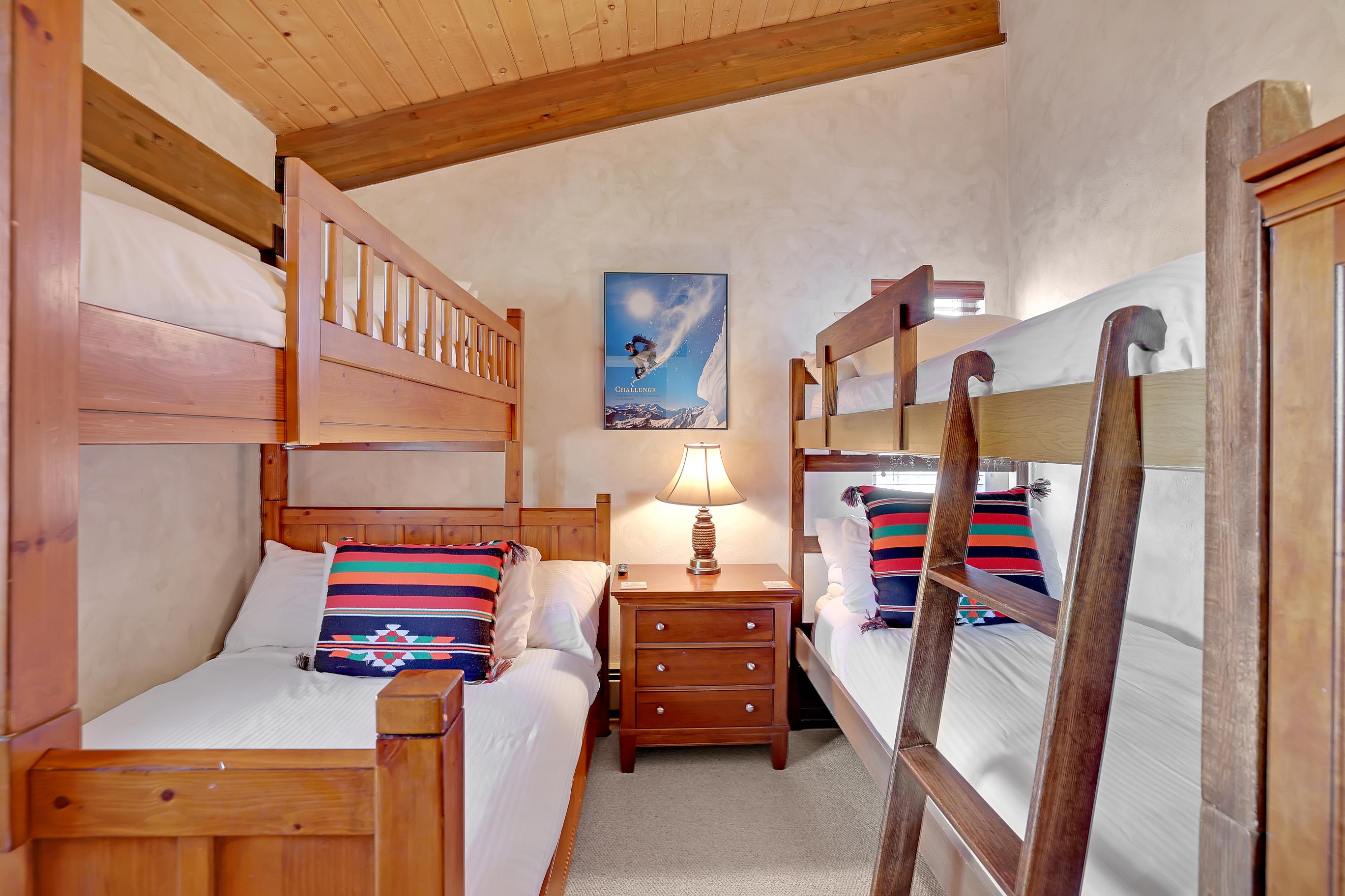 The bunk room includes 1 full size bed + 3 twin beds. A full dresser and closet provide ample storage.