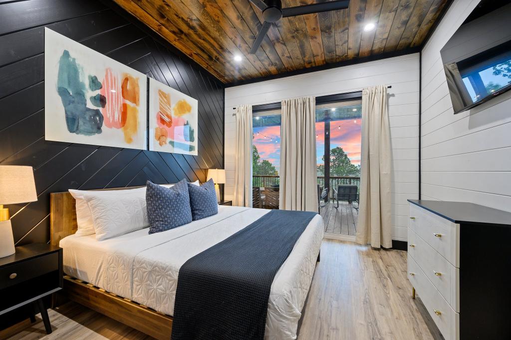 Lower level king bedroom with sliding door access and great views off back deck