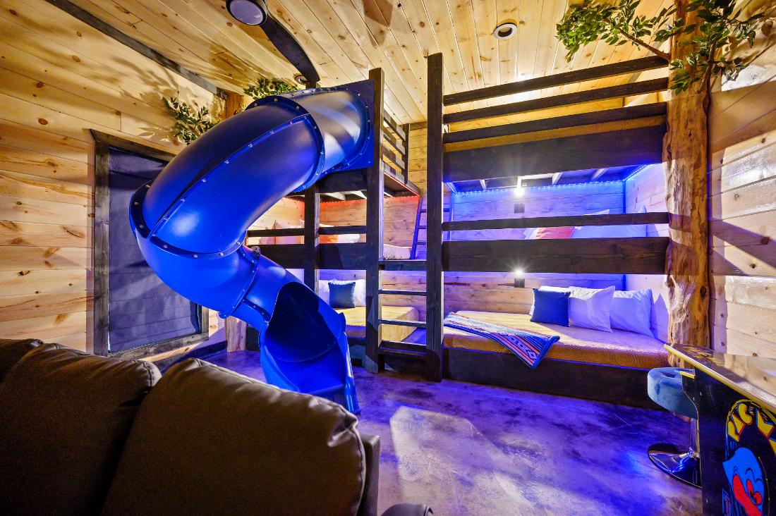  Create unforgettable memories at So Much Fawn, a family-friendly retreat featuring an indoor slide, game room, spacious covered deck, playground, and more—hosted by Great Escapes Homes.