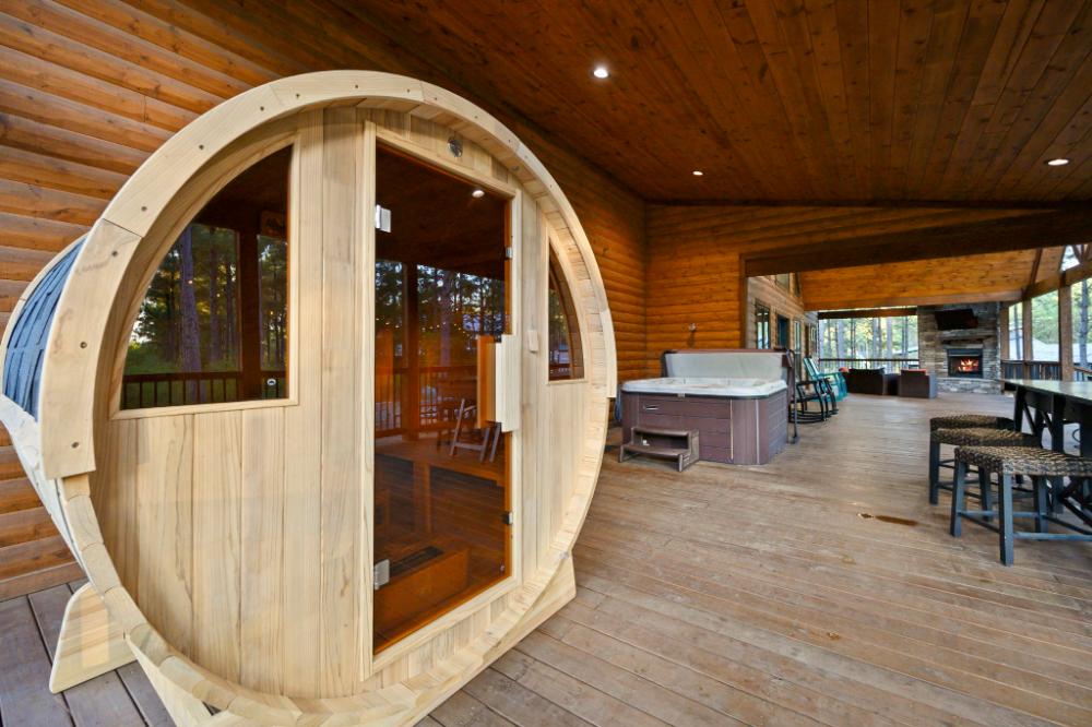 Barrel sauna, large hot tub, and so much more are all on the large, covered back deck.
