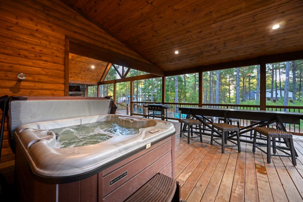 The expansive back deck provides loads of covered space with hot tub, outdoor dining/shuffleboard table, barrel sauna, and more!