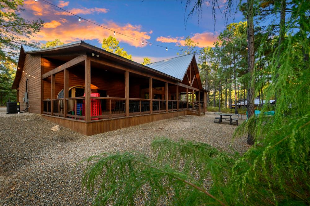 The back deck is huge and includes propane fireplace and seating, barrel sauna, hot tub, dining, Blackstone griddle, and rocking chairs.