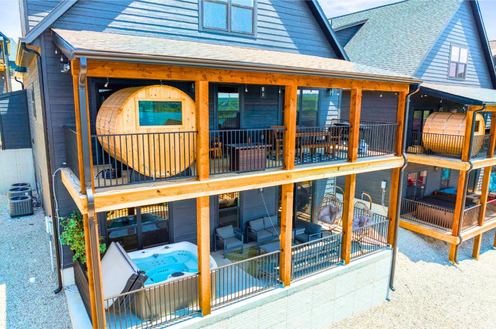 Two expansive decks offer space to unwind with a hot tub, barrel sauna, and lake views that stretch for miles.