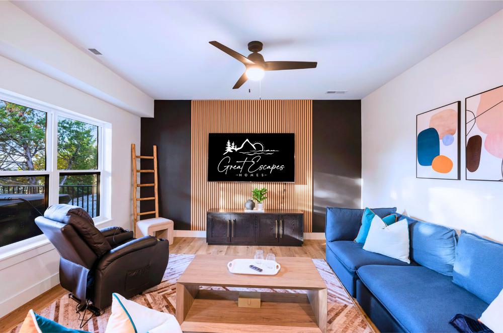 You can do it all In Great Escapes Homes! Stylish lower-level lounge featuring Smart TV, massage recliner, and plenty of natural light—perfect for relaxing after a day of fun. 