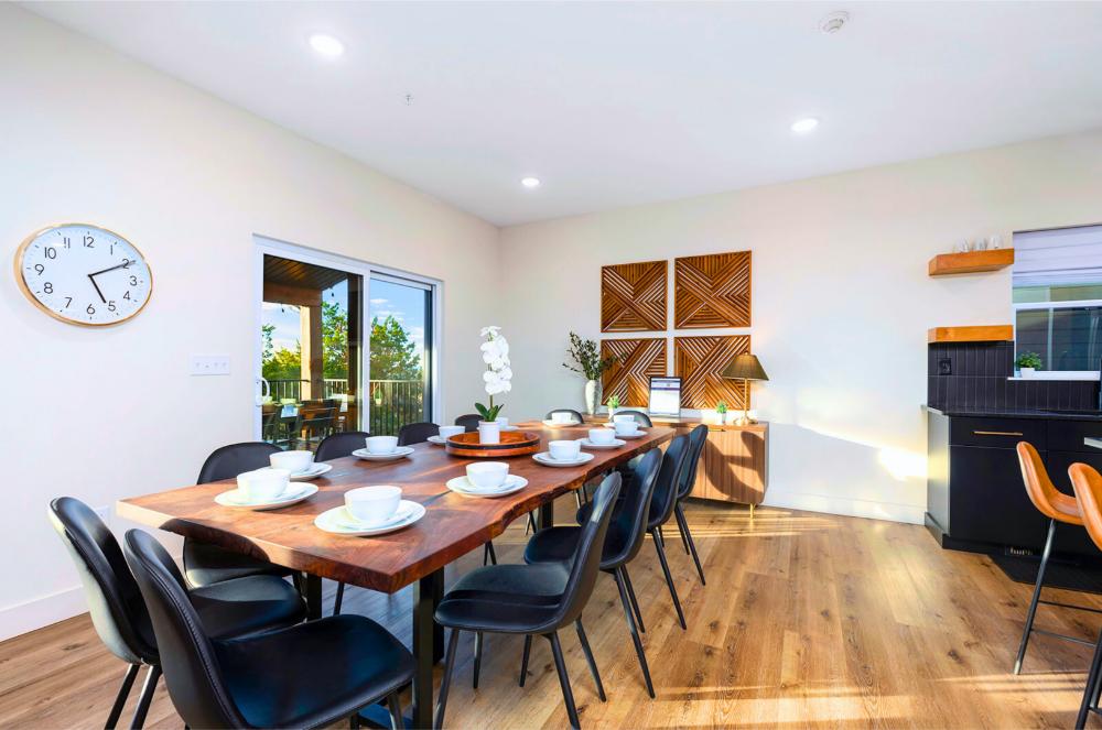 Gather at the handcrafted wood table, there’s room for everyone, including little ones in a high chair.