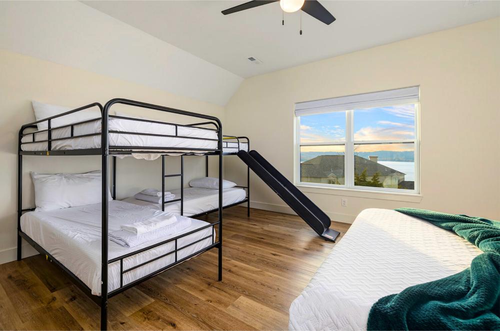 These four twin bunk beds with a built-in slide offer front-row sunset views over the lake.