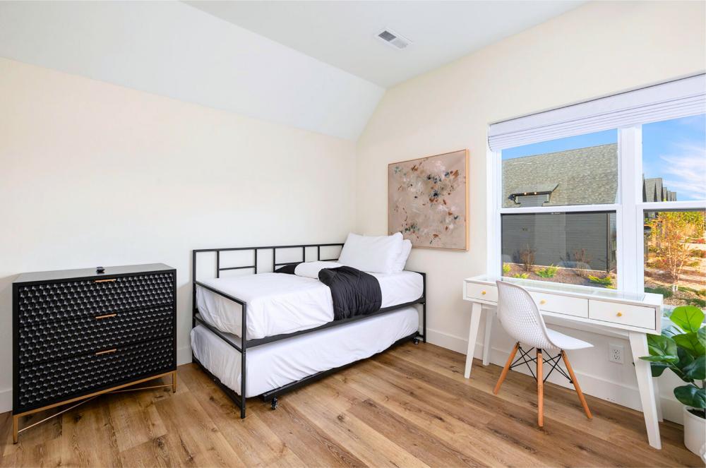 Spacious upstairs bedroom designed for families, complete with an ensuite bathroom and ample storage.