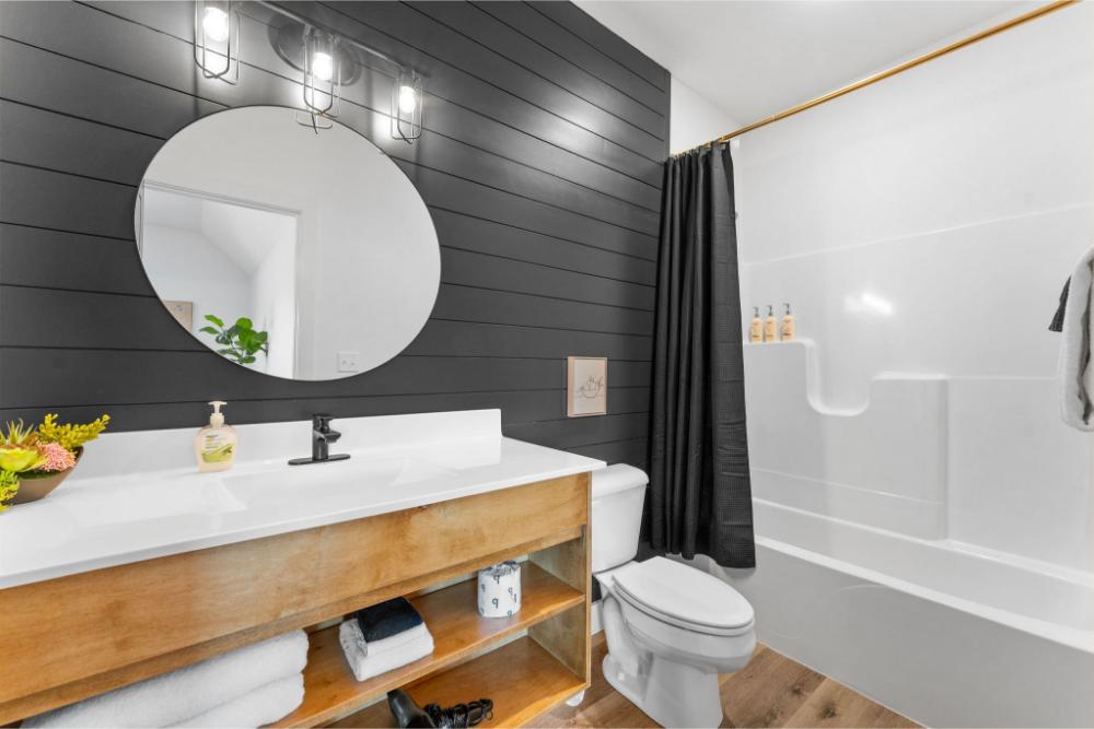Clean and inviting upstairs bathroom with a tub and shower combination.