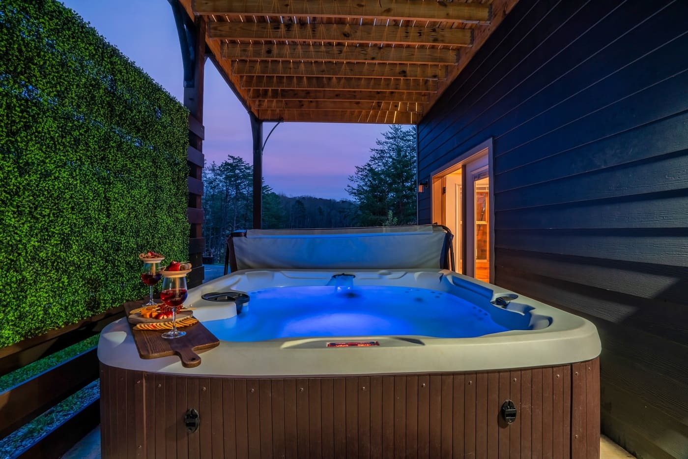 Hot tub at dusk with ambient lighting and scenic views.
