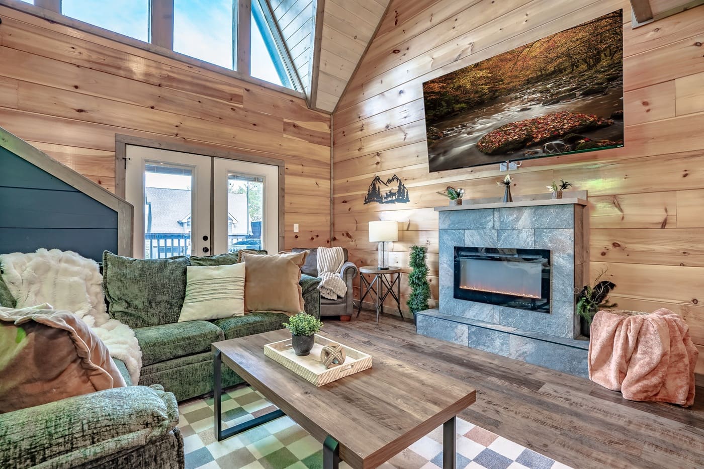 Relax in the cozy living room with soaring ceilings, a warm fireplace, and plenty of comfortable seating for everyone.