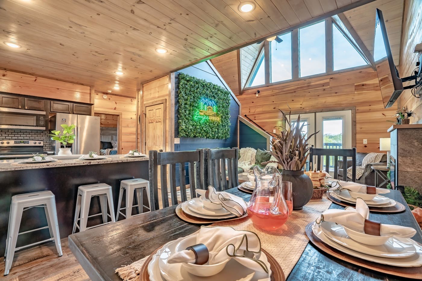 An open, inviting space where everyone can cook, dine, and relax together under warm wood finishes and natural light.