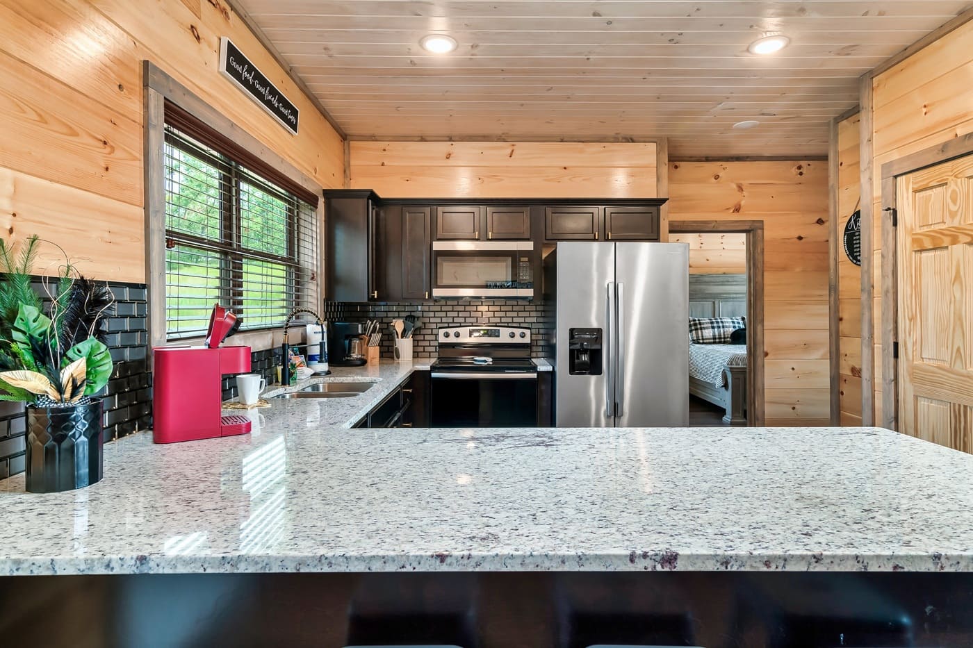 Cook with ease in a well-stocked kitchen featuring modern appliances and plenty of counter space.
