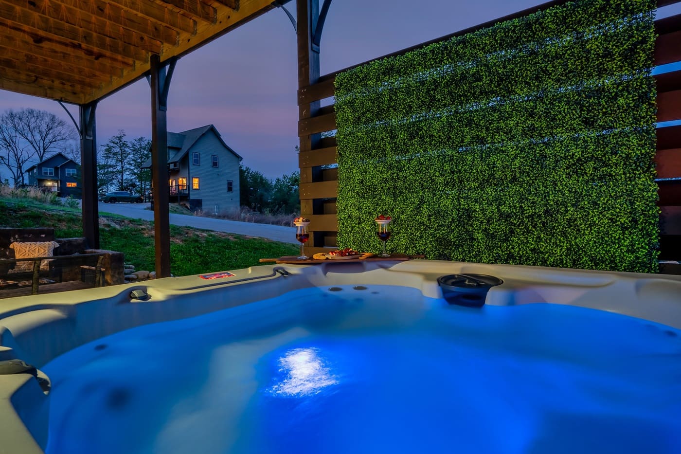A relaxing evening soak with glowing water, privacy, and a cozy setup for drinks and snacks.