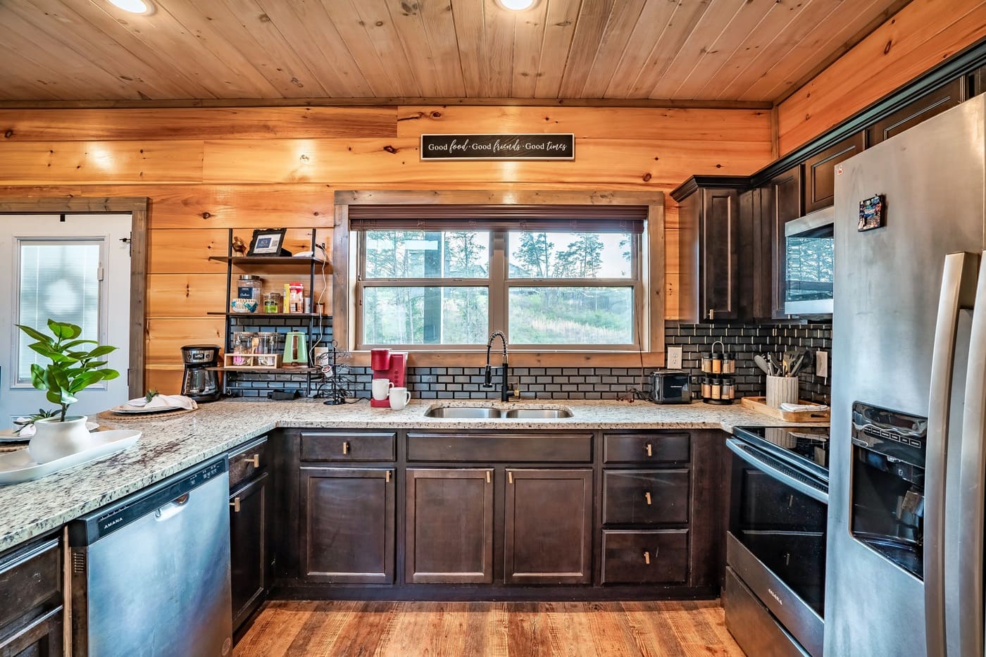 Kitchen with double sink, stainless steel appliances, and ample counter space.