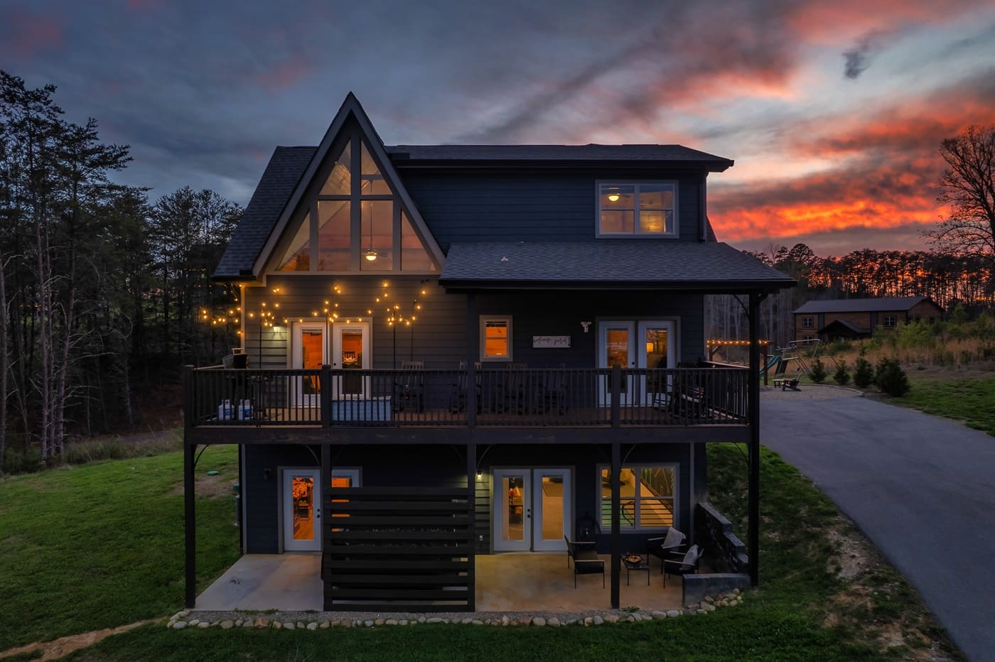 As the sun sets, the cabin glows with warm light, creating the perfect setting for a relaxing evening.