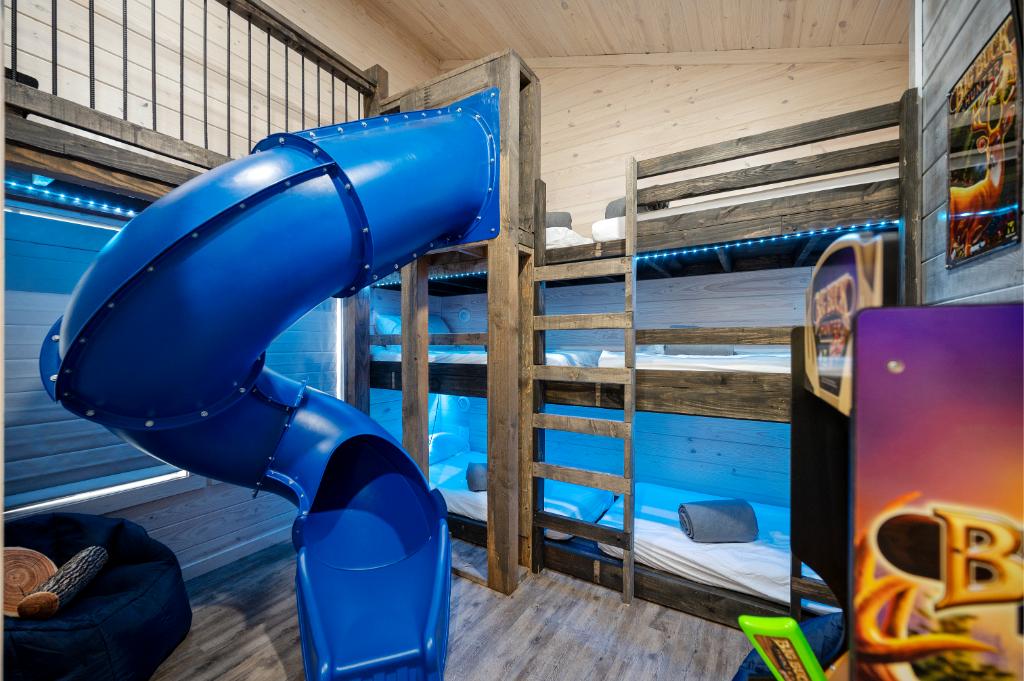 Kids love the bunk room, featuring a tube slide, secret path, play area above the bunks, and five twin bunk beds, plus a Street Fighter arcade.