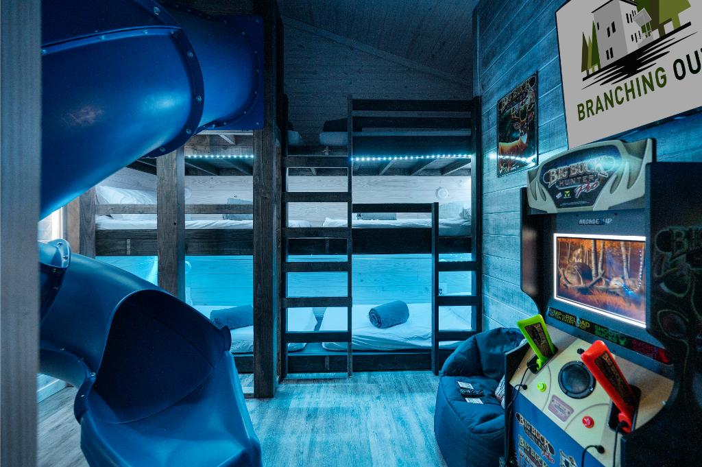 With color-changing lights, arcade games, and a slide, this bunk room is a fun-filled hangout for kids.