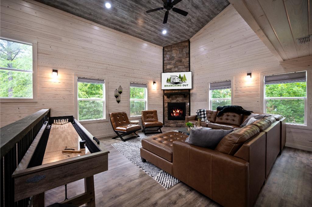 The upstairs den offers space for movie nights, board games, and shuffleboard for all ages.