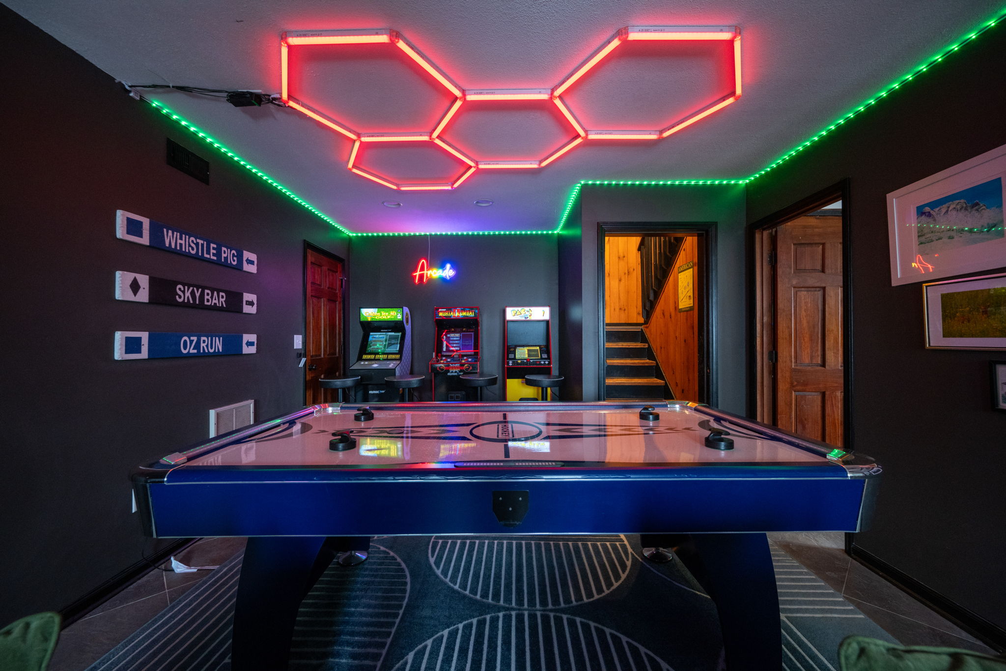 The basement arcade and game space with custom lighting creates a fun an unique atmosphere sure to create lasting memories for the entire group