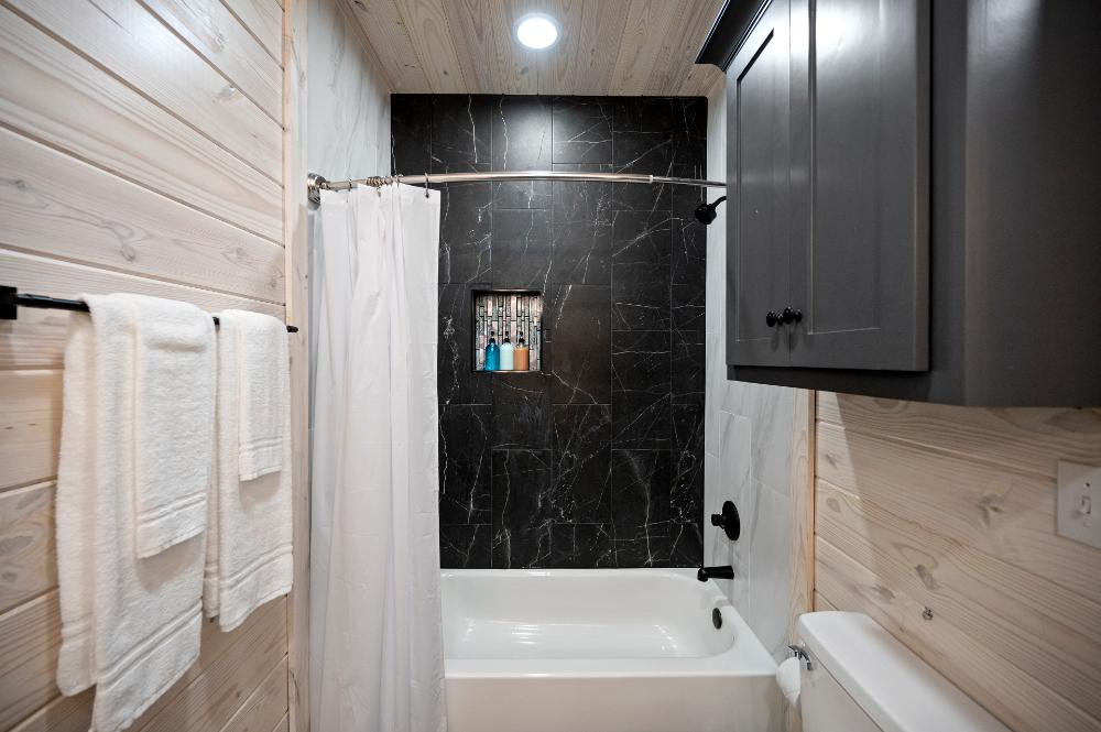 Bathroom with tub and shower combination for guest convenience.