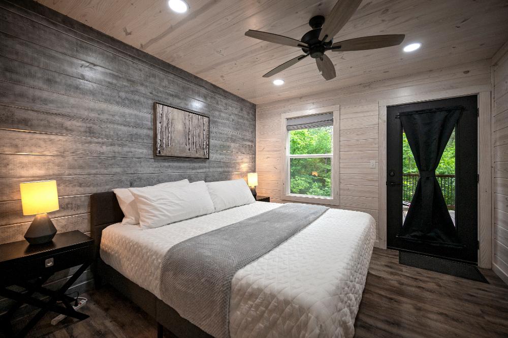 Start your day with fresh air from this king bedroom with direct access to the deck.