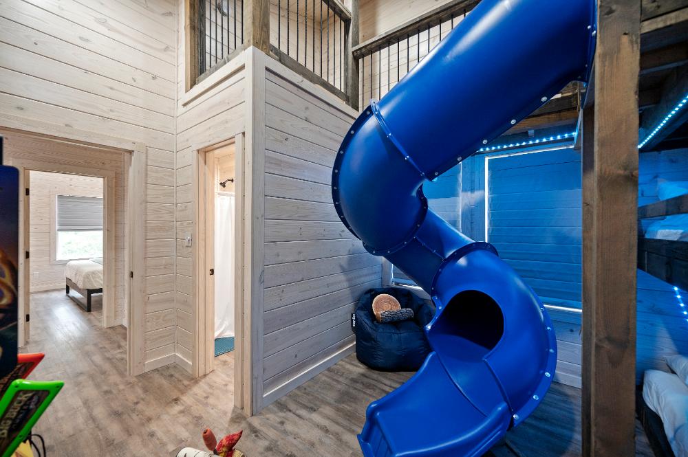 Slides, stories, and sleepovers await in this bunk room filled with built-in fun for kids.