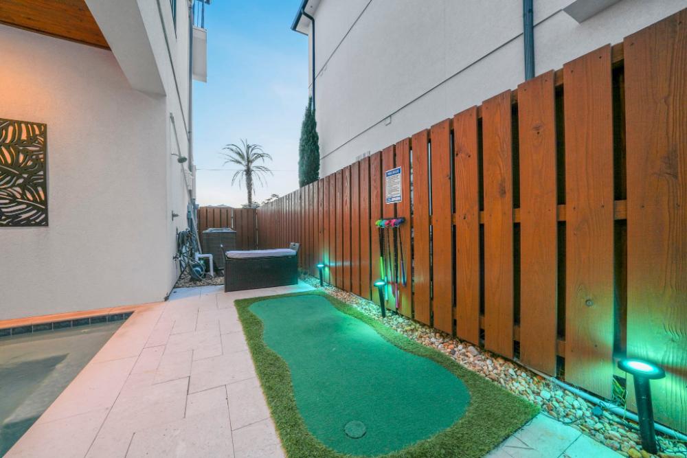 Hit a few putts, then rinse off in the outdoor shower—just steps from the pool and perfect after a beach day.