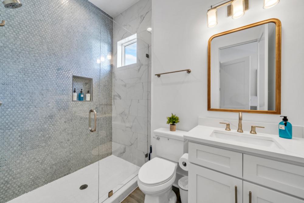 Refresh in this beautifully tiled shower—modern touches that make every rinse feel like a spa day.