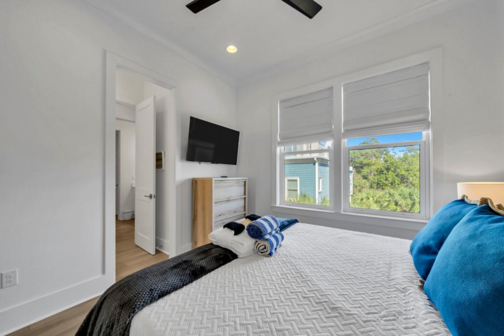 Rest easy in this king bedroom with all the comforts—smart TV, plenty of storage, and a shared ensuite just steps away