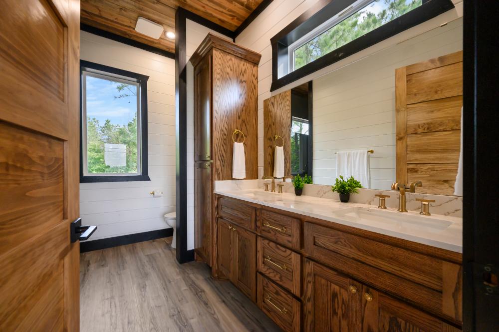 A main-floor king-size bedroom with a trundle bed, private ensuite, and a scenic mountain outlook right outside the window.