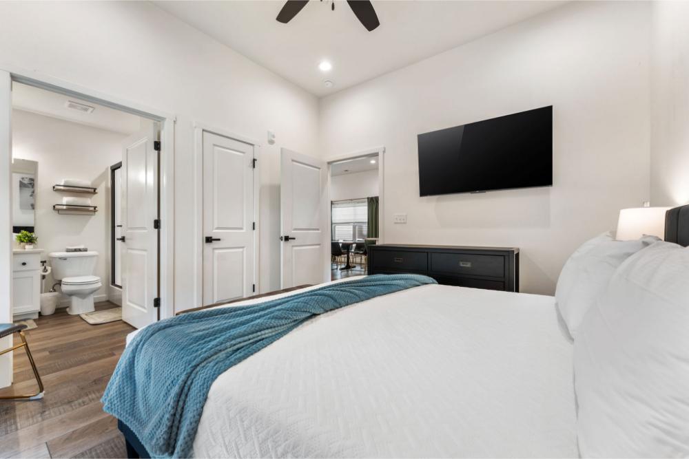This main floor king suite offers convenient access, a comfortable bed, and a private TV for added relaxation.