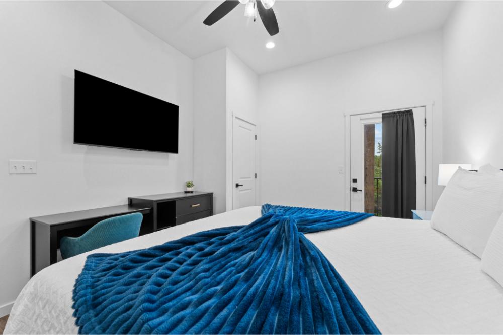 A comfortable workspace with desk and TV makes it easy to balance productivity and relaxation.