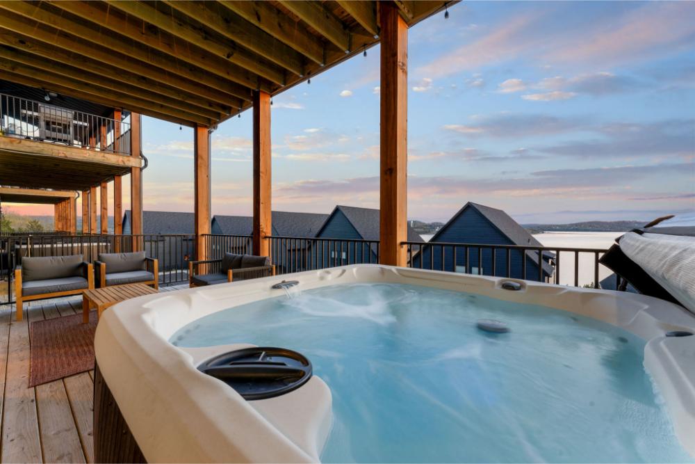 Private hot tub located on the back deck with expansive lake views.