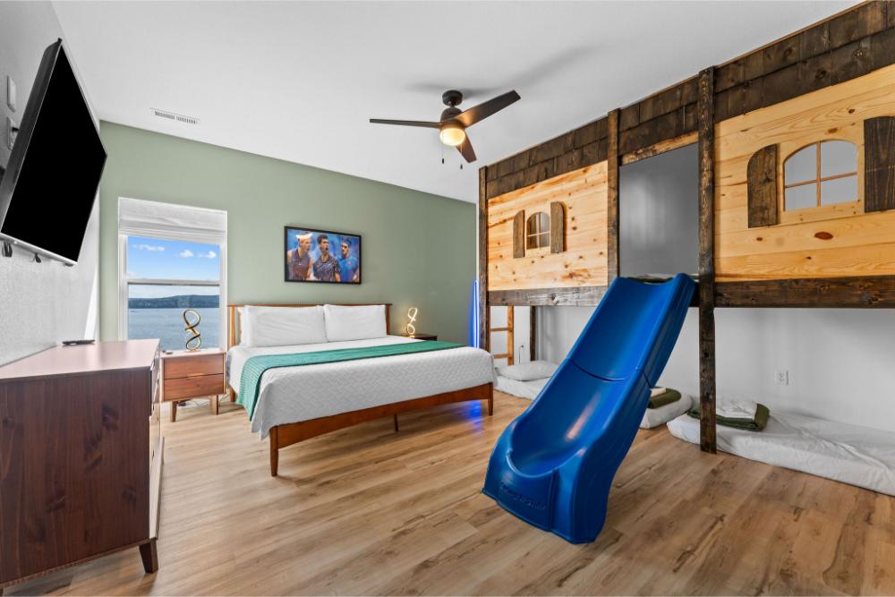 This fun bunk room features four twin beds and a built-in slide for added excitement.