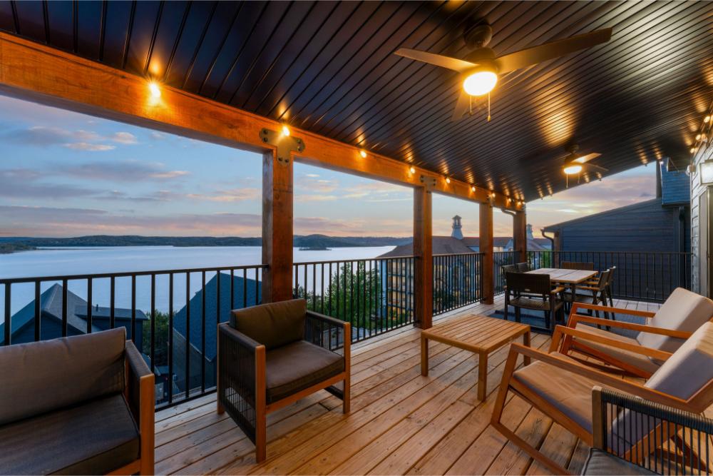 Covered outdoor deck offers ample seating and panoramic lake views for memorable outdoor dining.