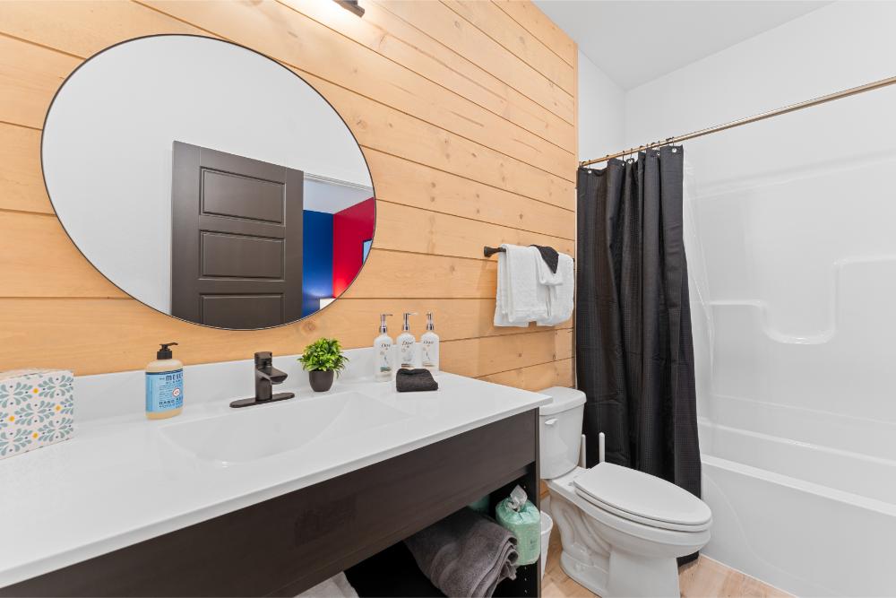 This spacious bathroom offers a comfortable and functional design suited for any part of your day.