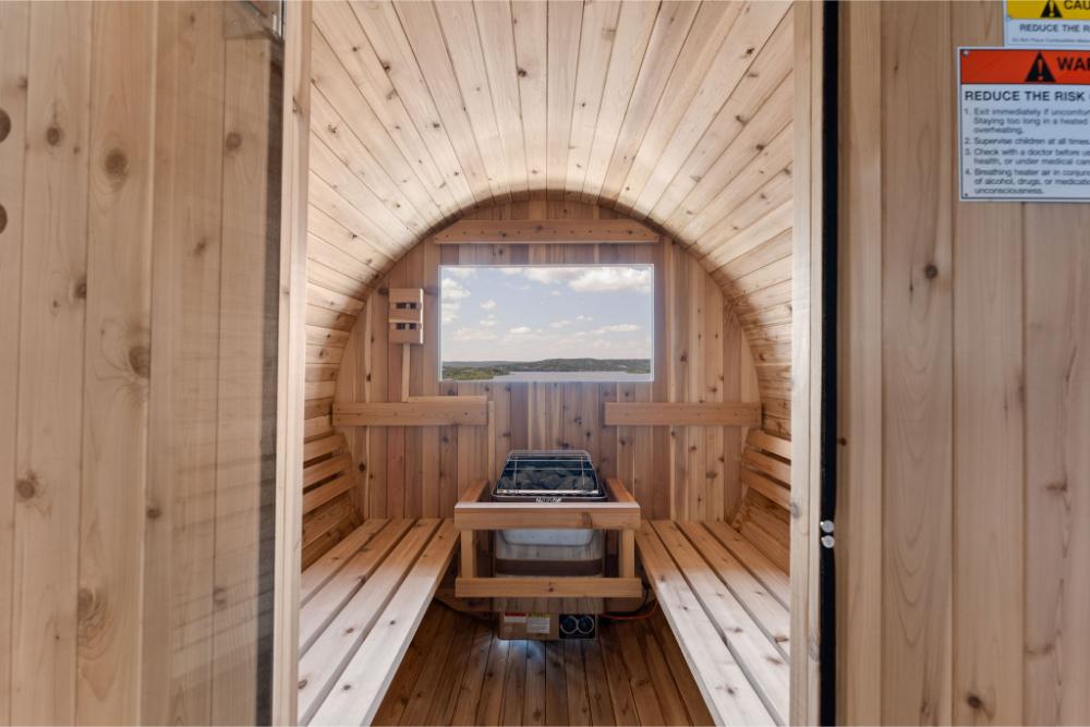 Private barrel sauna offers a relaxing retreat complemented by peaceful lake views.