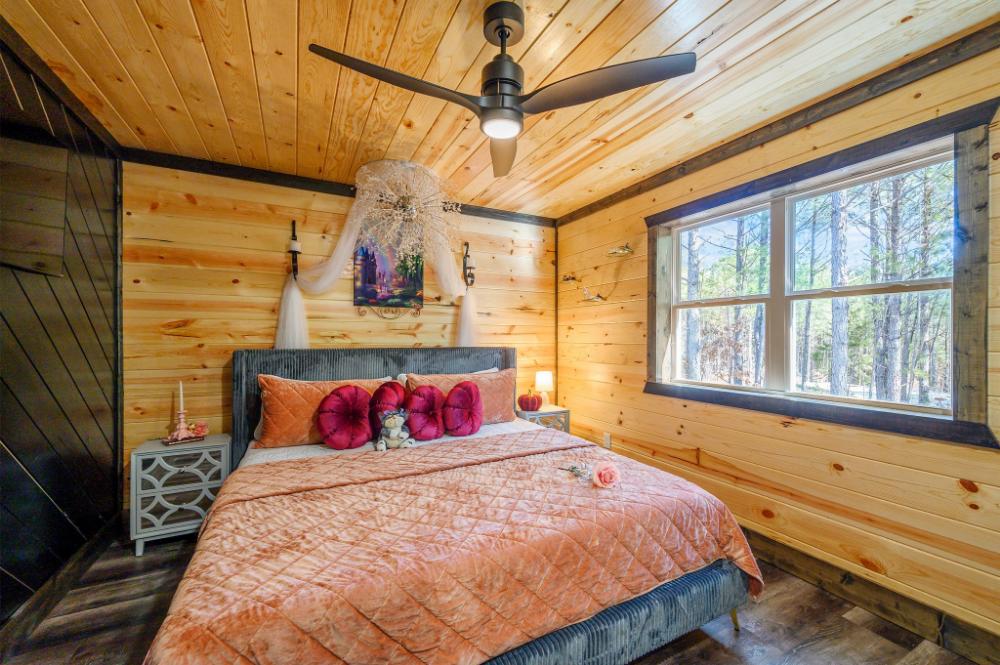 Upstairs king bedroom with scenic forest views.