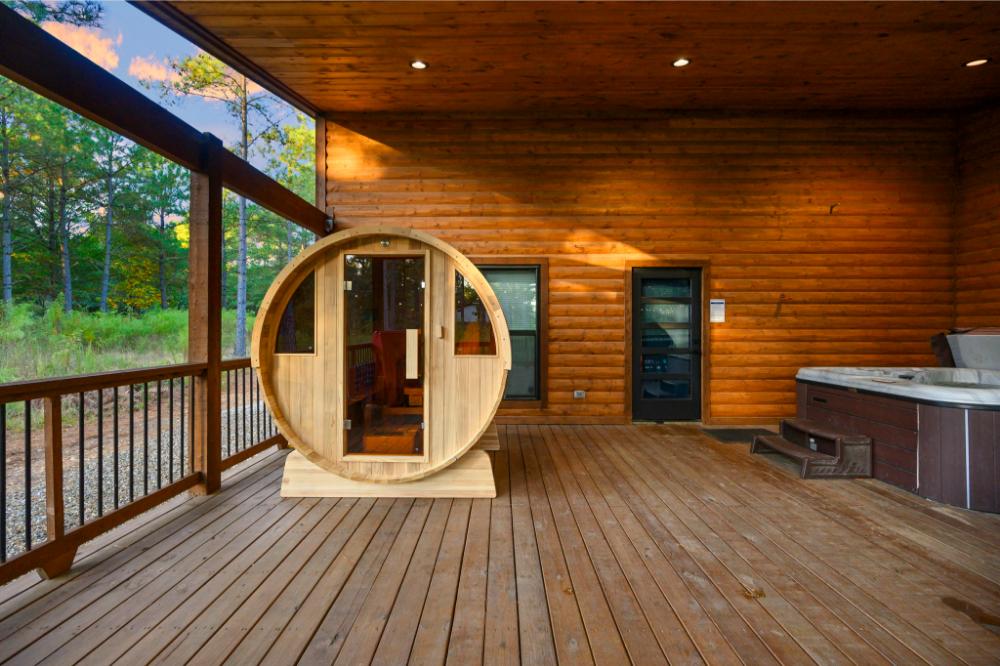 The side-by-side barrel sauna and hot tub on the covered deck offer a relaxing space to unwind.
